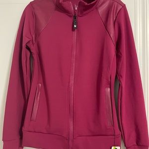 Nicole Miller sports zip up.